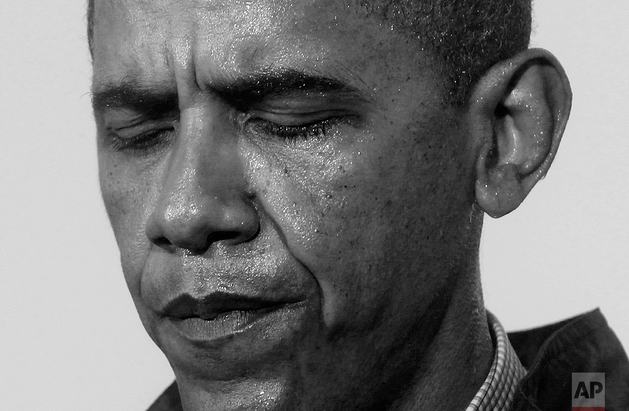 Standing in the rain, President Barack Obama pauses as he makes a statement to reporters at the Coast Guard Venice Station in Venice, La., as he visits the Gulf Coast region affected by the BP oil well spill, Sunday, May 2, 2010. (AP Photo/Charles Dharapak)