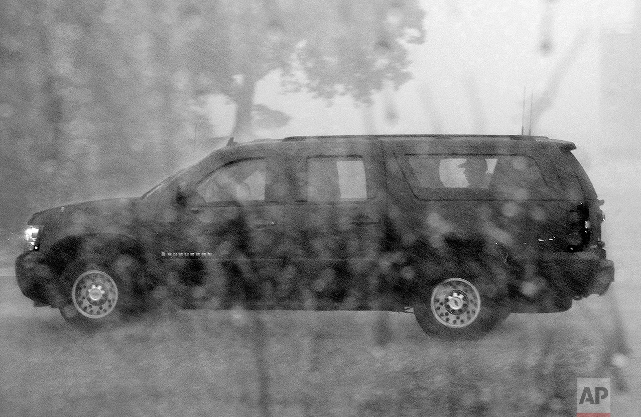 President Barack Obama is seated in his sports utility vehicle as he is driven from Andrews Air Force Base, Md., as his round of golf was ended by a sudden storm, Sunday, July 25, 2010. (AP Photo/Charles Dharapak)