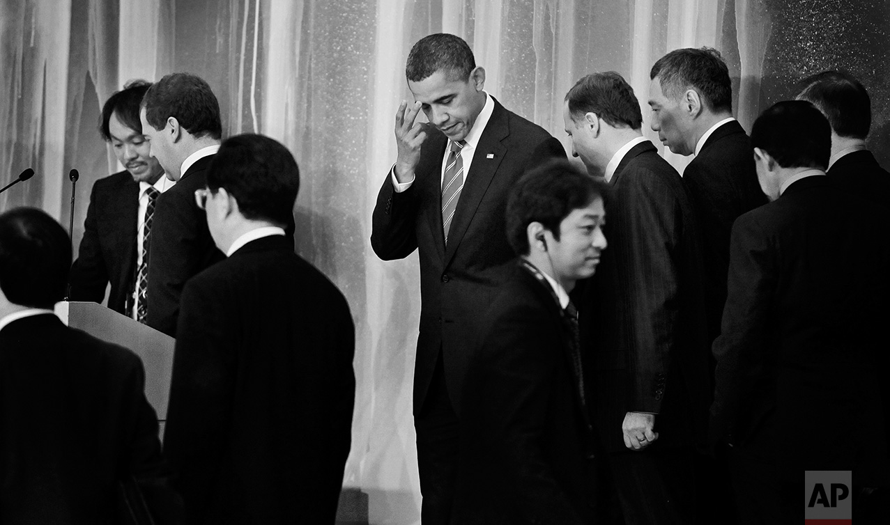 President Barack Obama, center, is pictured as world leaders file past before the leaders declaration at the Asia Pacific Economic Summit in Yokohama, Japan, Sunday, Nov. 14, 2010. Pictured are President Hu Jintao of China, President Dmitry Medvedev of Russia, Prime Minister John Key of New Zealand, and Prime Minister Lee Hsien Loong of Singapore. (AP Photo/Charles Dharapak)