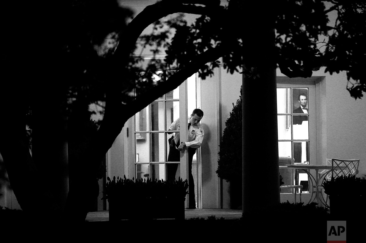 A Uniformed Division Secret Service officer checks the door to the Oval Office of the White House in Washington ahead of an evening meeting between President Barack Obama, House Speaker John Boehner, R- Ohio and Senate Majority Leader Harry Reid, D-Nev., regarding the budget and possible government shutdown, Wednesday, April 6, 2011. (AP Photo/Charles Dharapak)