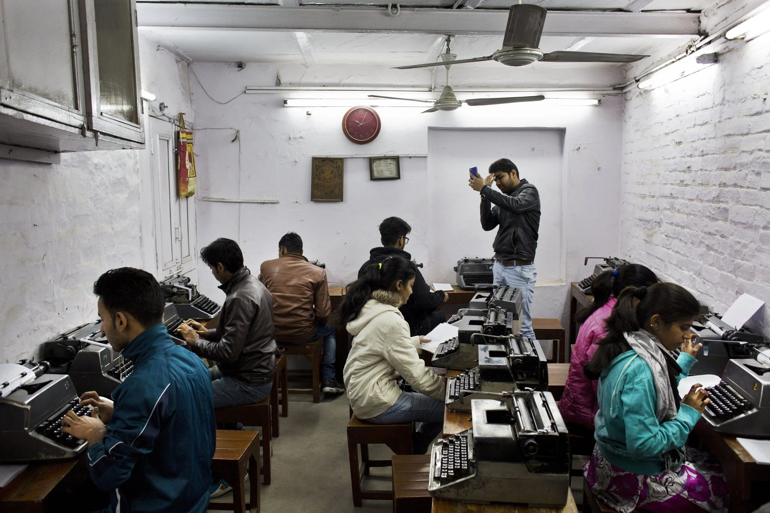In this Jan. 17, 2017 photo, Indian students practice at a local typewriting school in New Delhi, India. Twenty years ago, there were hundreds of little typing schools in New Delhi, crowded with university students, aspiring clerks and young women hoping for jobs as secretaries. There are still typing schools that, at least occasionally, are jammed with students. But even in this country, one of the last places in the world where the typewriter remains a part of everyday life, the end is, finally, coming. (AP Photo/Bernat Armangue)