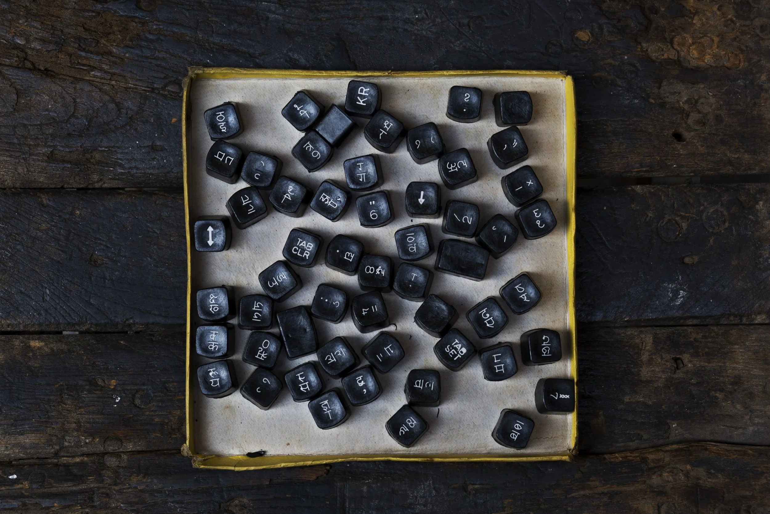 In this Jan. 16, 2017 photo, Hindi language typewriter keyboard spares lie in a box in New Delhi, India. India still has a few thousand remaining professional typists. There are a handful of typewriter repairmen and stores selling spare parts. There are typing schools that, at least occasionally, are jammed with students. But even in this country, one of the last places in the world where the typewriter remains a part of everyday life, the end is, finally, coming. (AP Photo/Bernat Armangue)