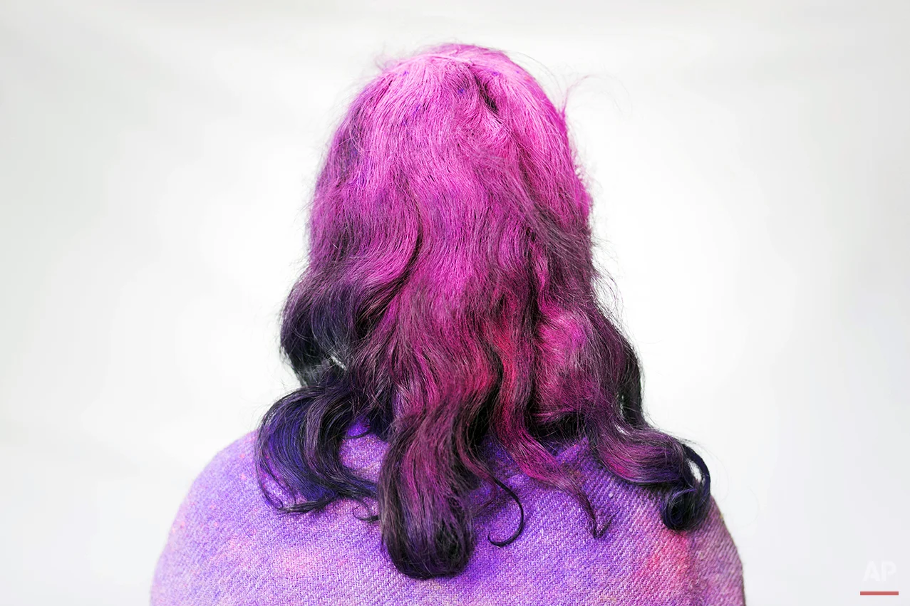 In this Tuesday, March 3, 2015 photo, Hindu widow Sima Chohan, 40, poses for a portrait after celebrating Holi at the Meera Sahabhagini Widow Ashram in Vrindavan, India. Hundreds of widows gathered Tuesday at the Ashram to celebrate the Hindu festival of spring and India’s riotous annual celebration of color. (AP Photo/Bernat Armangue)