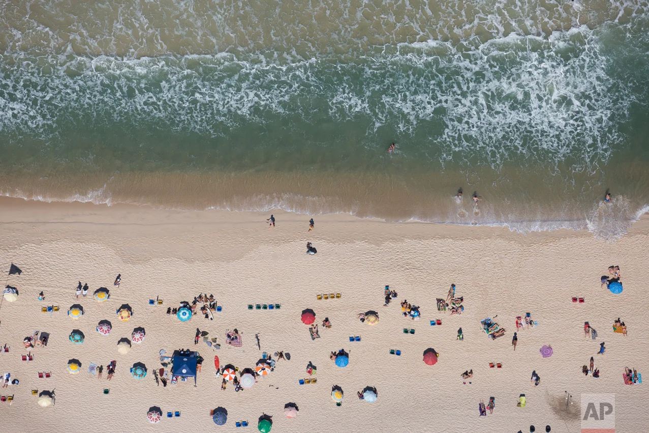 People sunbathe at Ipanema beach in Rio de Janeiro, Brazil, Monday, Aug. 1, 2016. The Summer Games start Aug. 5. (AP Photo/Felipe Dana)