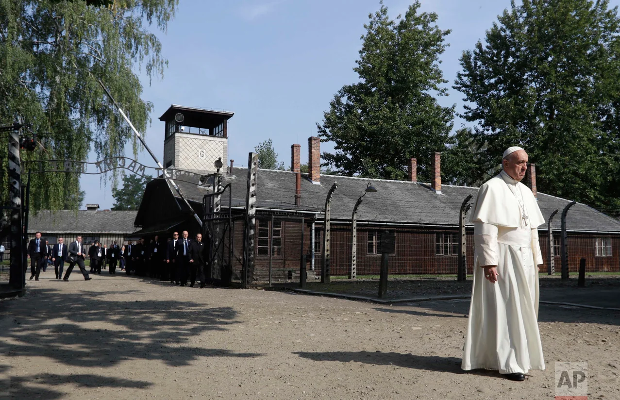 Pope Francis walks through the gate of the former Nazi German death camp of Auschwitz in Oswiecim, Poland, Friday, July 29, 2016. Pope Francis paid a somber visit to the Nazi German death camp of Auschwitz-Birkenau Friday, becoming the third consecutive pontiff to make the pilgrimage to the place where Adolf Hitler's forces killed more than 1 million people, most of them Jews. (AP Photo/Gregorio Borgia)