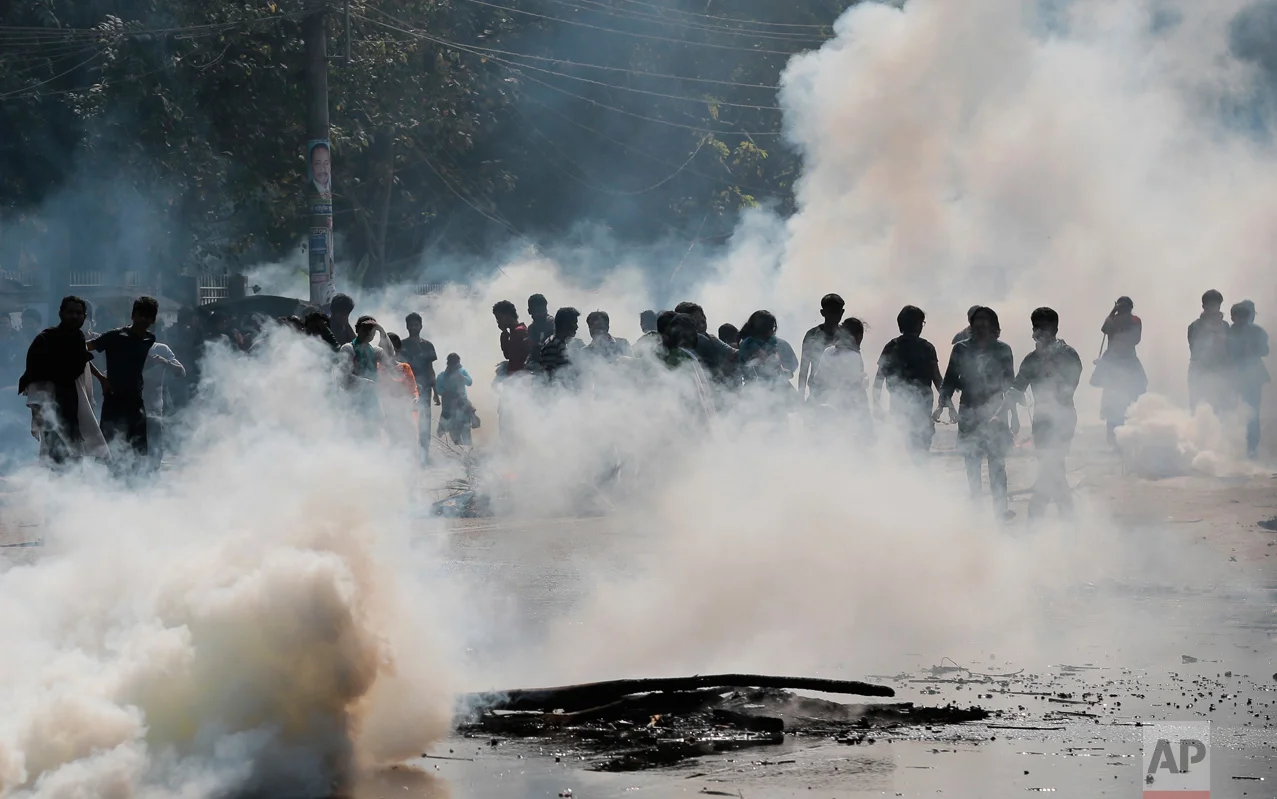 Police launch tear gas shells to disperse protestors demanding the cancellation of a plan for a massive coal-fired power plant near ecologically sensitive mangrove forests on the coast in Dhaka, Bangladesh, on Thursday, Jan. 26, 2017. The government insists that the planned 1.3-gigawatt Rampal power station near the Sundarbans, a world heritage site, is key to reaching its target of 24 gigawatts of electrical capacity by 2021. (AP Photo)