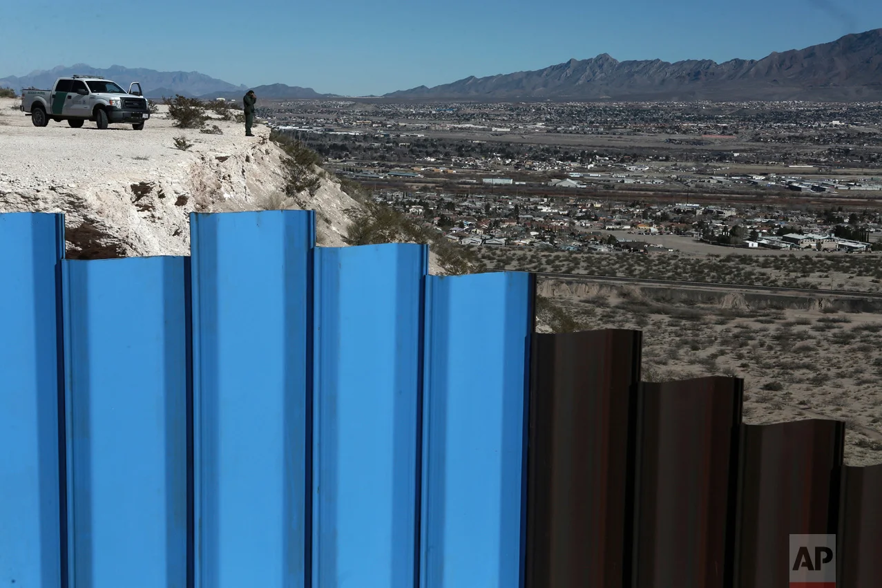 A border patrol agent, watches the Mexico-U.S. border fence, on the Mexican side, separating the towns of Anapra, Mexico and Sunland Park, N.M., on Wednesday, Jan. 25, 2017. (AP Photo/Christian Torres)