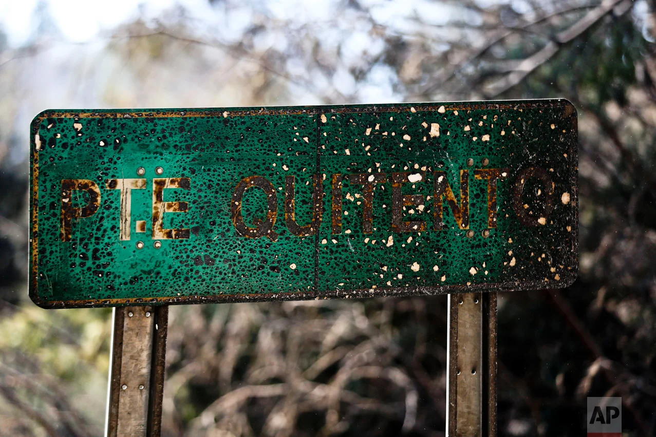 This Monday, Jan. 30, 2017 photo shows a road sign scorched by wildfires in Portezuelo, Chile. More than 20,000 people, including firefighters and experts from more than a dozen countries, continue to battle wildfires that President Michelle Bachelet has called the worst forest disaster in Chile's history. (AP Photo/Esteban Felix)
