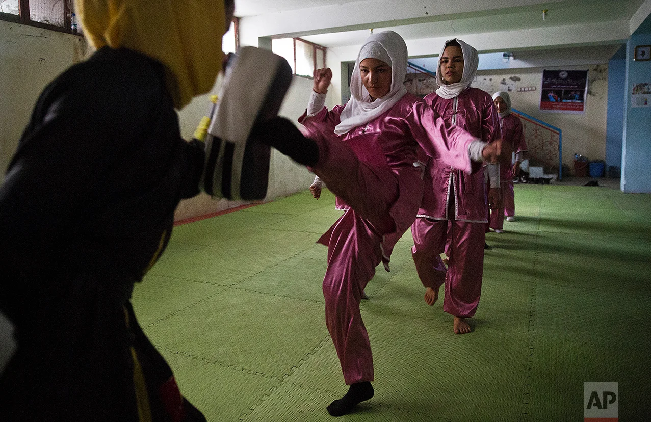 Shaolin martial arts students practice at their club in Kabul, Afghanistan, Tuesday, Jan. 25, 2017. When they aren’t training on the snow covered hills that surround Kabul, Azimi, teacher wearing black, trains her students in a grungy, dark club financed by a young cinema actor. (AP Photos/Massoud Hossaini)