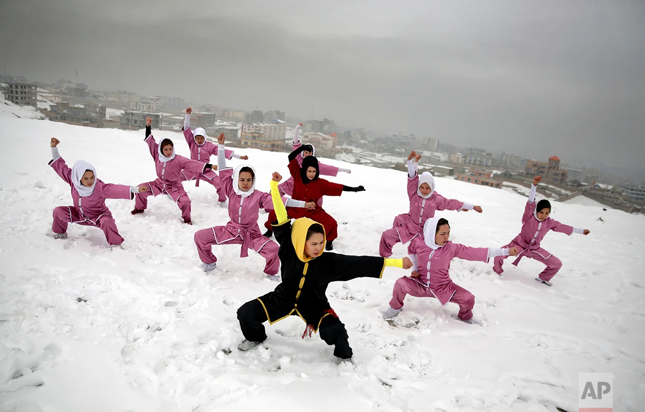 Shaolin martial arts students follow their trainer, Sima Azimi, 20, in black, during a training session on a hilltop in Kabul, Afghanistan, Tuesday, Jan. 25, 2017. Sima Azimi, 20, who is originally from Jaghuri in central Afghanistan, trains nine students in the martial arts to prepare for Olympic competitions, but also to protect themselves on the streets of Kabul, where women are routinely harassed. (AP Photos/Massoud Hossaini)
