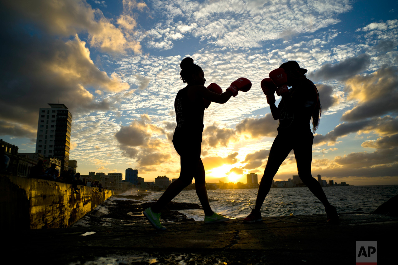 In this Jan. 30, 2017 photo, boxers Idamelys Moreno, left, and Legnis Cala, train during a photo session on Havana's sea wall, in Cuba. Moreno and Cala are part of a group of up-and-coming female boxers on the island who want government support to form Cuba's first female boxing team and help dispel a decades-old belief once summed up by a former top coach: "Cuban women are meant to show the beauty of their face, not receive punches." (AP Photo/Ramon Espinosa)