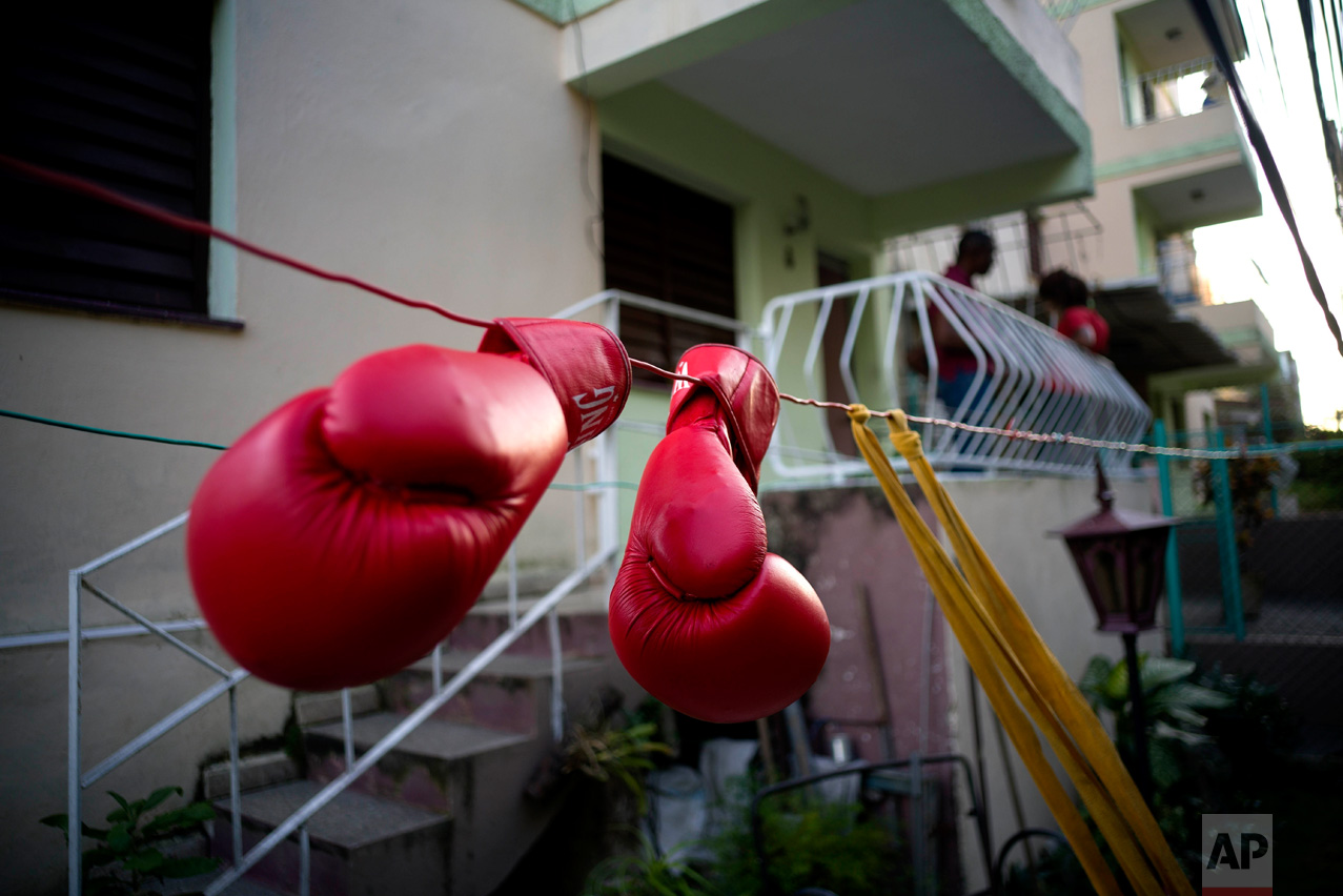 In this Jan. 19, 2017 photo, Idamelys Moreno's boxing gloves hang on a line to dry, after a training session in Havana, Cuba. Women were first allowed to box at the Olympics during the 2012 Summer Olympics but they are still not allowed to box in Cuba. (AP Photo/Ramon Espinosa)