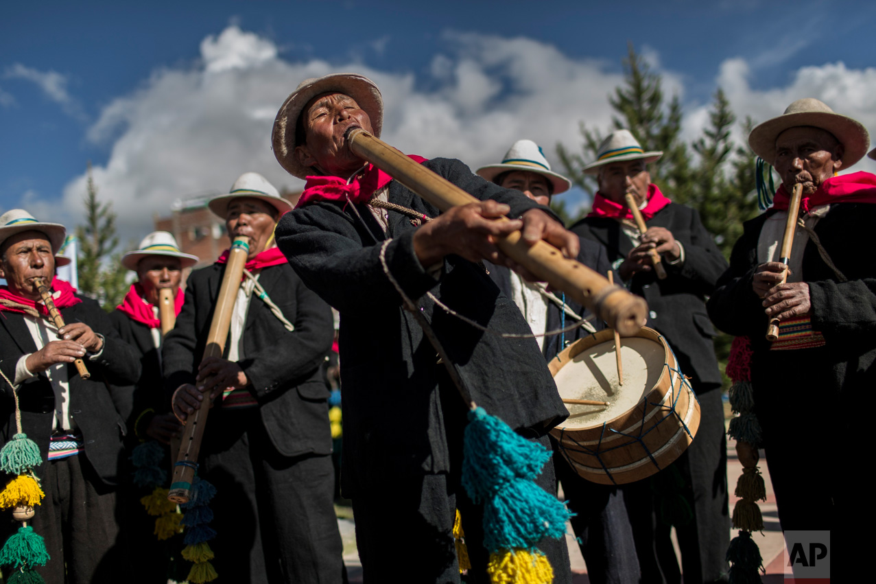 In this Jan. 29, 2017 photo, musicians perform for dancers on the shores of Lake Titicaca, as they practice before their presentation for the Virgin of Candelaria celebrations in Puno, Peru. Dancers in colorful masks and elaborate costume celebrate …