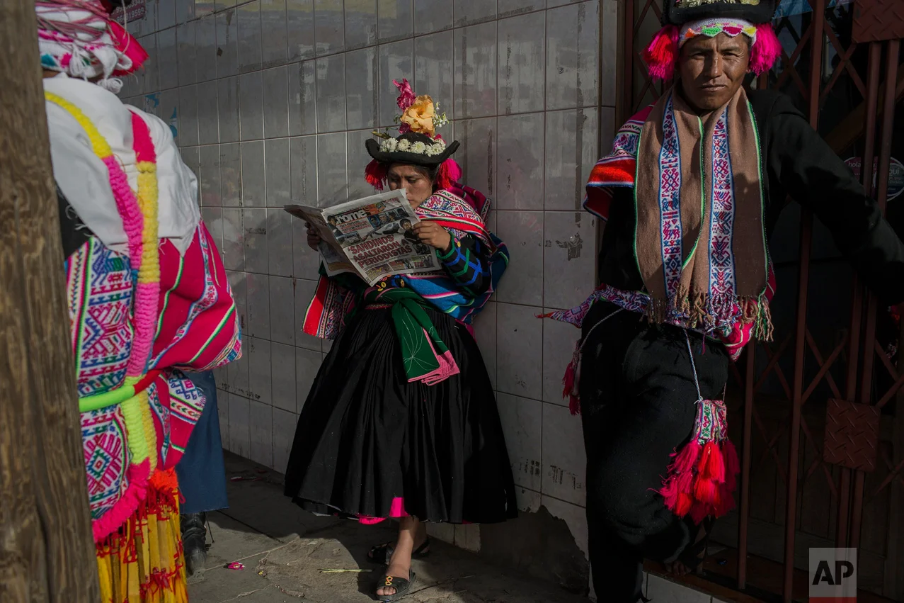 In this Jan. 29, 2017 photo, a dancer reads a newspaper while waiting to perform during Virgin of Candelaria celebrations in Puno, Peru. As many as 40,000 villagers are expected to gather for the annual festival and show their respect for the patron…