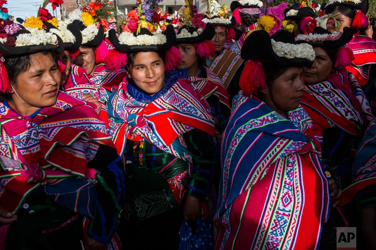 In this Jan. 29, 2017 photo, dancers wait their turn to perform during Virgin of Candelaria celebrations in Puno, Peru. In addition to devotion, villagers have other reasons for dancing on the feast. Some are grateful to have been cured of disease, …