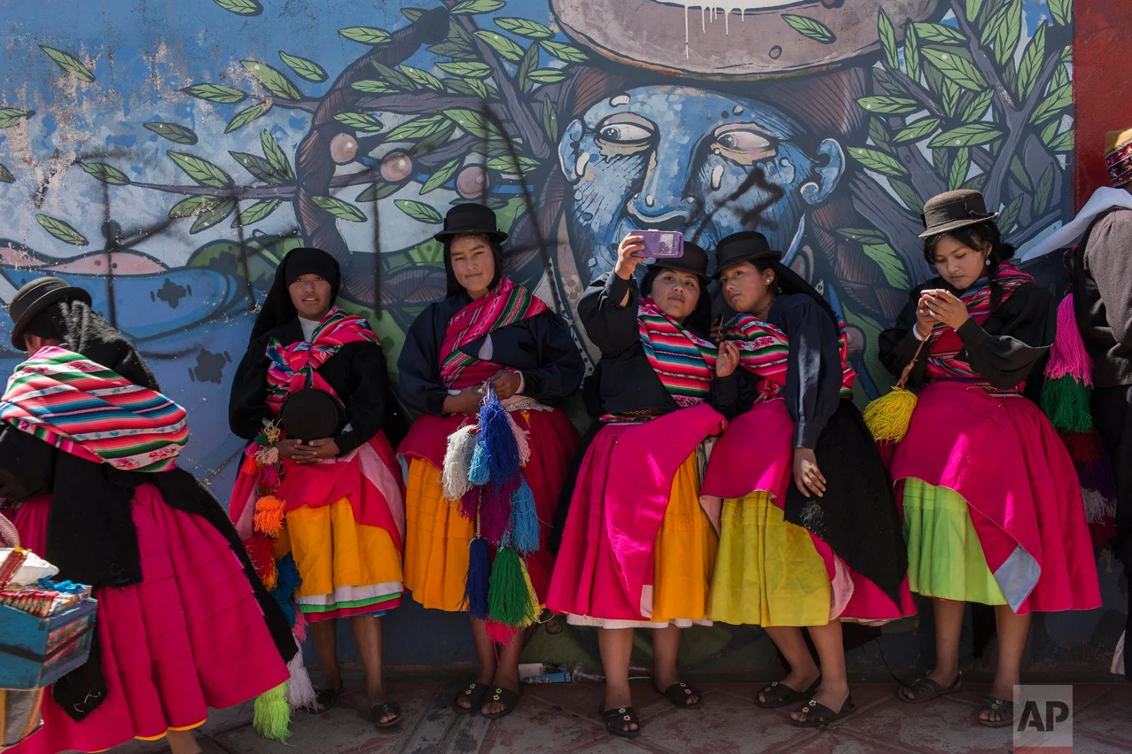 In this Jan. 29, 2017 photo, dancers take selfies after performing during Virgin of Candelaria celebrations in Puno, Peru. The festival of La Candelaria has been celebrated in Puno every year since the 18th century. UNESCO declared the festival a cu…
