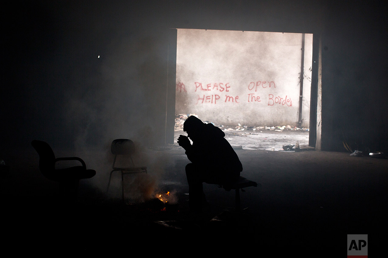  Refugee Samiuallah Ahmadi, 18, from Kabul, Afghanistan warms himself around a fire in an abandoned warehouse in Belgrade, Serbia, Saturday, Jan. 28, 2017. (AP Photo/Muhammed Muheisen) 