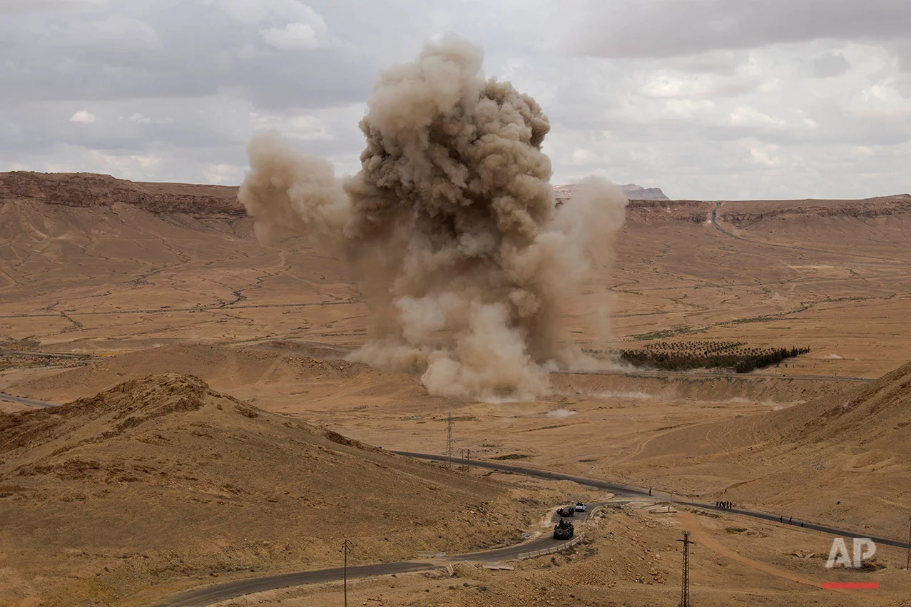 Smoke rises from a controlled land mine detonation by Russian experts in the ancient town of Palmyra in the central Homs province, Syria, Thursday, April 14, 2016. Russian combat engineers arrived in Syria on a mission to clear mines in Palmyra, which has been recaptured from Islamic State militants in an offensive that has proven Russia’s military might in Syria despite a drawdown of its warplanes. (AP Photo/Hassan Ammar)