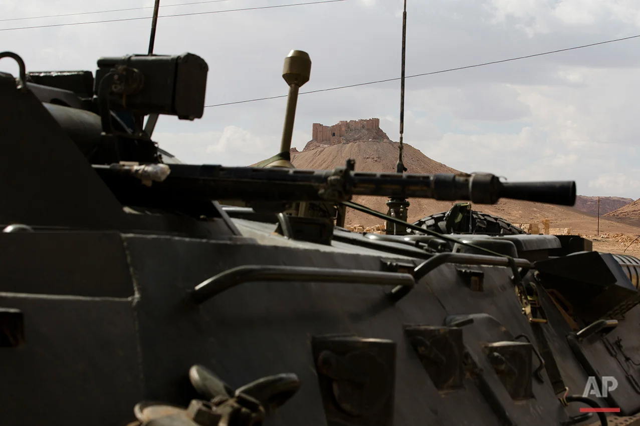 Palmyra citadel is seen as a Russian Vehicle blocks a road leads to the ancient city of Palmyra in the central Homs province, Syria, Thursday, April 14, 2016. Russian combat engineers are in Syria on a mission to clear mines in Palmyra, which has been recaptured from Islamic State militants in an offensive that has proven Russia’s military might in Syria despite a drawdown of its warplanes. (AP Photo/Hassan Ammar)
