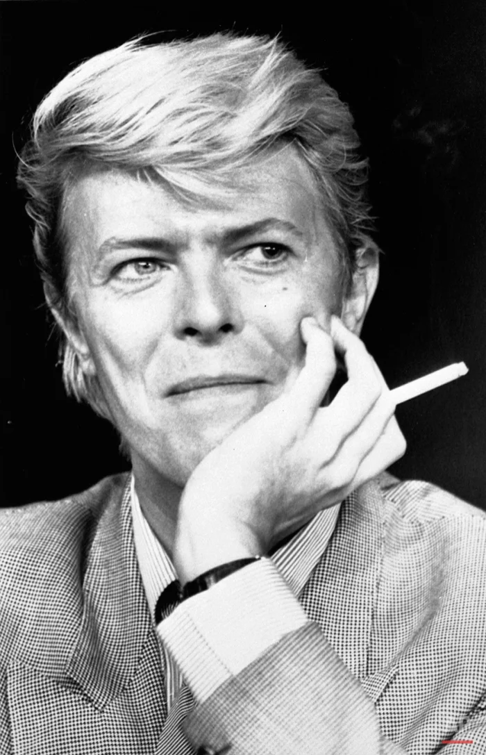 David Bowie sits holding a cigarette in Cannes, May, 1983. (AP Photo)