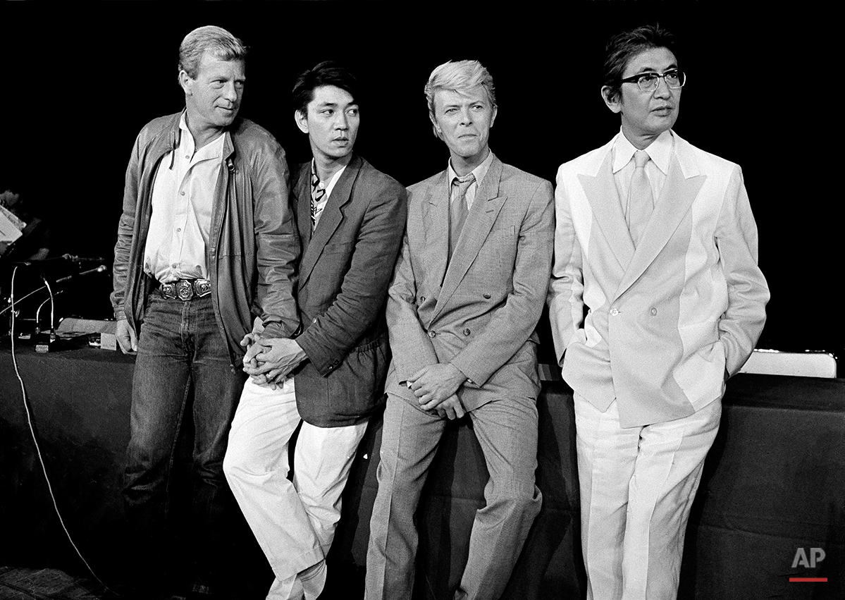 The team that created the film “Merry Christmas, Mr. Lawrence” is pictured in Paris, May 11, 1983. From left: Jack Thomas, producer; Ryuichi Sakamoto, musical composer; David Bowie, star, and Nagisa Oshima, director. (AP Photo/Jacques Langevin)