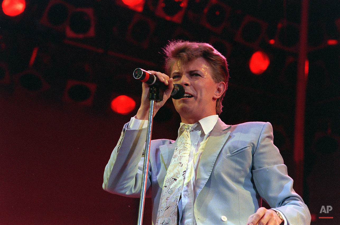 Rock star David Bowie performs on stage at Wembley Stadium, London, July 13, 1985, during the Live Aid famine relief rock concert. (AP Photo/Joe Schaber)