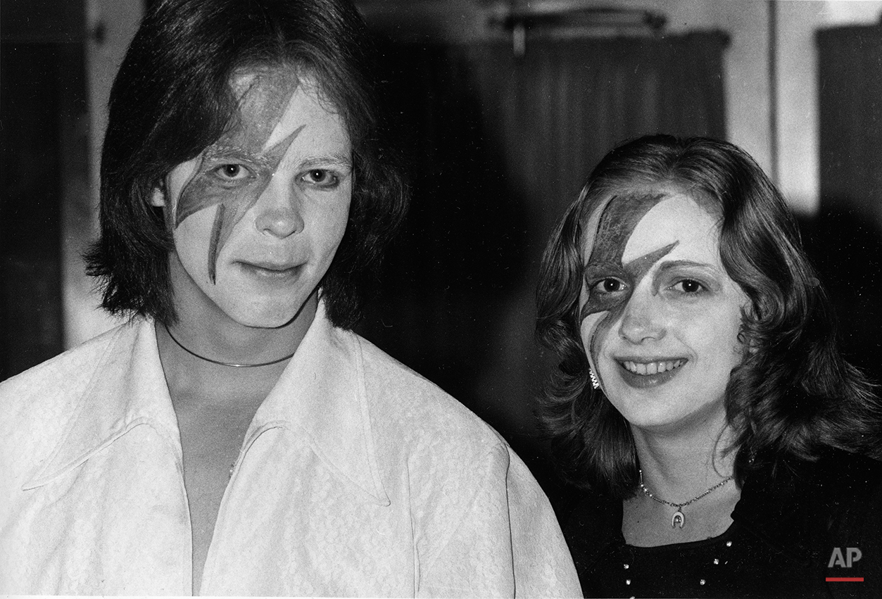 Two fans of glitter-rock singing star David Bowie wears makeup at Bowie's weekend concert at New York's Radio City Music Hall, Nov. 3, 1974. (AP Photo/Suzanne Vlamis)