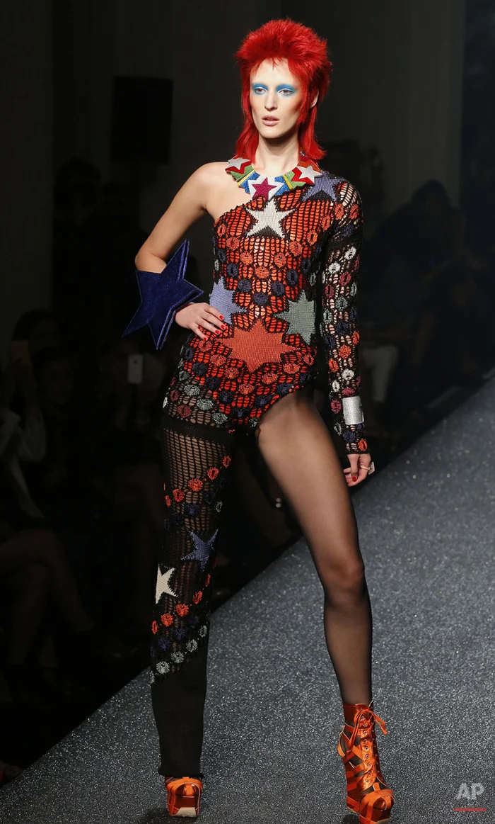 In this Sept.29, 2012 photo, model Hannelore Knuts wears a creation by French fashion designer Jean-Paul Gaultier during the presentation of his ready to wear Spring-Summer 2013, in Paris. The look channels the style of late pop icon David Bowie, as part of the rock star-themed show. Bowie died on Sunday Jan.10, 2016. He was 69. (AP Photo/Jacques Brinon)