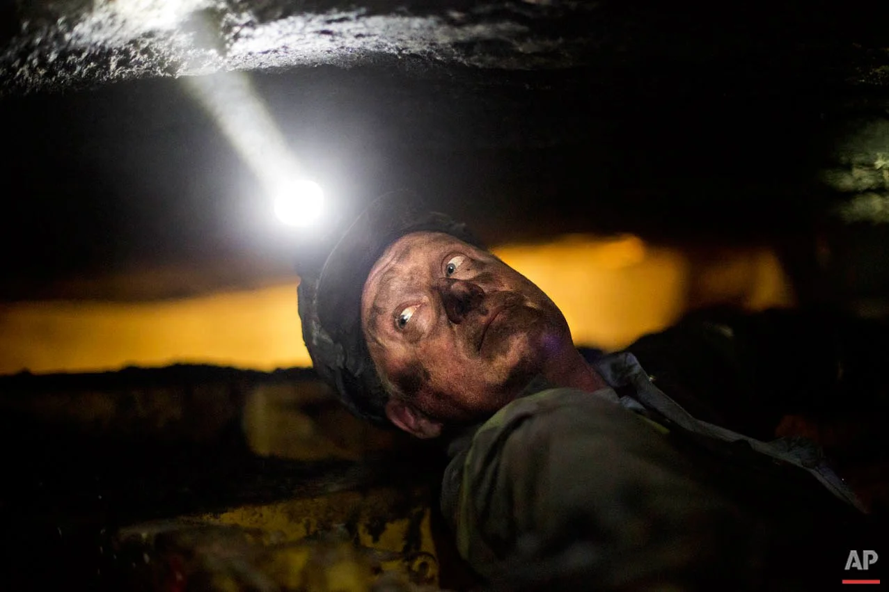 Scott Tiller, a coal miner of 31 years, takes a break while operating a continuous miner machine in a coal mine roughly 40-inches-high, Tuesday, Oct. 6, 2015, in Welch, W.Va. The seams of coal in the mine are so thin workers can barely squeeze down them. They enter on carts nearly flat on their backs, the roof of the mine coursing by just a few inches in front of their faces. They don’t stand up all day. (AP Photo/David Goldman)