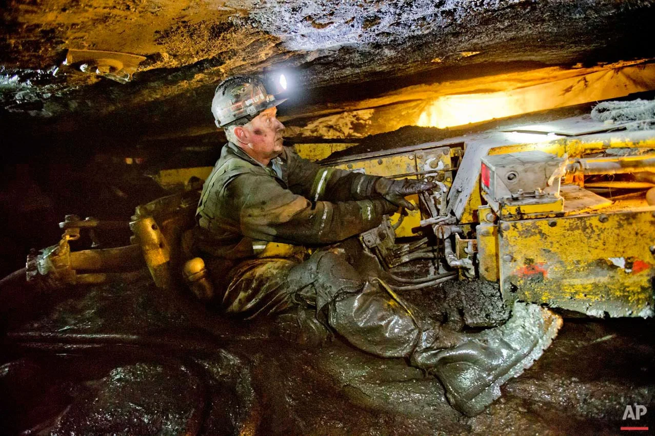 Scott Tiller, a coal miner of 31 years, operates a continuous miner machine in a coal mine roughly 40-inches-high, Tuesday, Oct. 6, 2015, in Welch, W.Va. Most of the job losses happened long before coal’s latest downturn. Mechanization began slashing the number of workers needed to mine coal in the 1960s, and then a collapse in the U.S. steel industry in 1980s further decimated miners’ ranks. (AP Photo/David Goldman)
