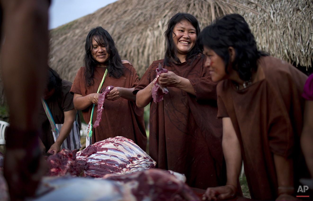  In this June 22, 2015 photo, Ashaninka Indian women skim fat from the meat of a cow in the village Otari Nativo, Pichari, Peru. The cow was donated by municipal authorities to mark the 44th anniversary of the community's founding. The community’s me