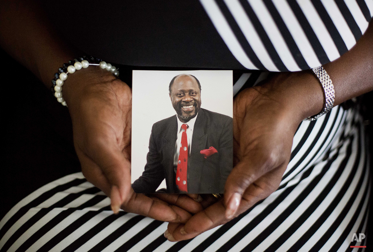 Annie Simmons, wife of 24 years of Daniel Simmons Sr., one of the nine people killed in Wednesday's shooting at Emanuel AME Church, holds a photo of her husband at her home Friday, June 19, 2015, in North Charleston, S.C. (AP Photo/David Goldman)