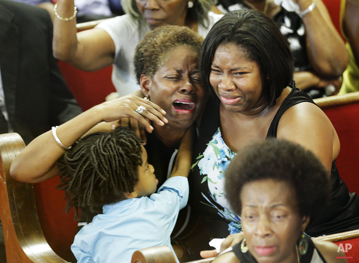 Parishioners pray and weep during the first service at the Emanuel A.M.E. Church Sunday, June 21, 2015, in Charleston, S.C., since a mass shooting claimed the lives of its pastor and eight others four days earlier. (AP Photo/David Goldman, Pool)
