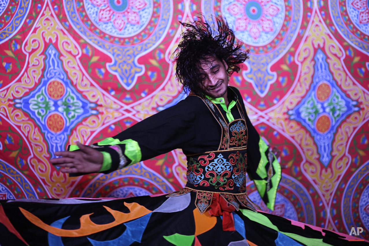 In this Friday, June 12, 2015 photo, whirling dervish Mahmoud Rizk, spins during a performance held by the Al-Tannoura Egyptian Heritage Dance Troupe, at the Darb 1718 cultural center, in Cairo, Egypt. (AP Photo/Amr Nabil)
