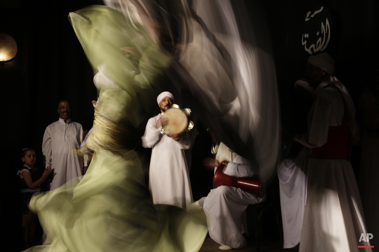 In this Thursday, April 30, 2015 photo, a whirling dervish spins during a performance in collaboration with the Al-Tannoura Egyptian Heritage Dance Troupe at the El Dammah Theatre in Cairo, Egypt. (AP Photo/Amr Nabil)