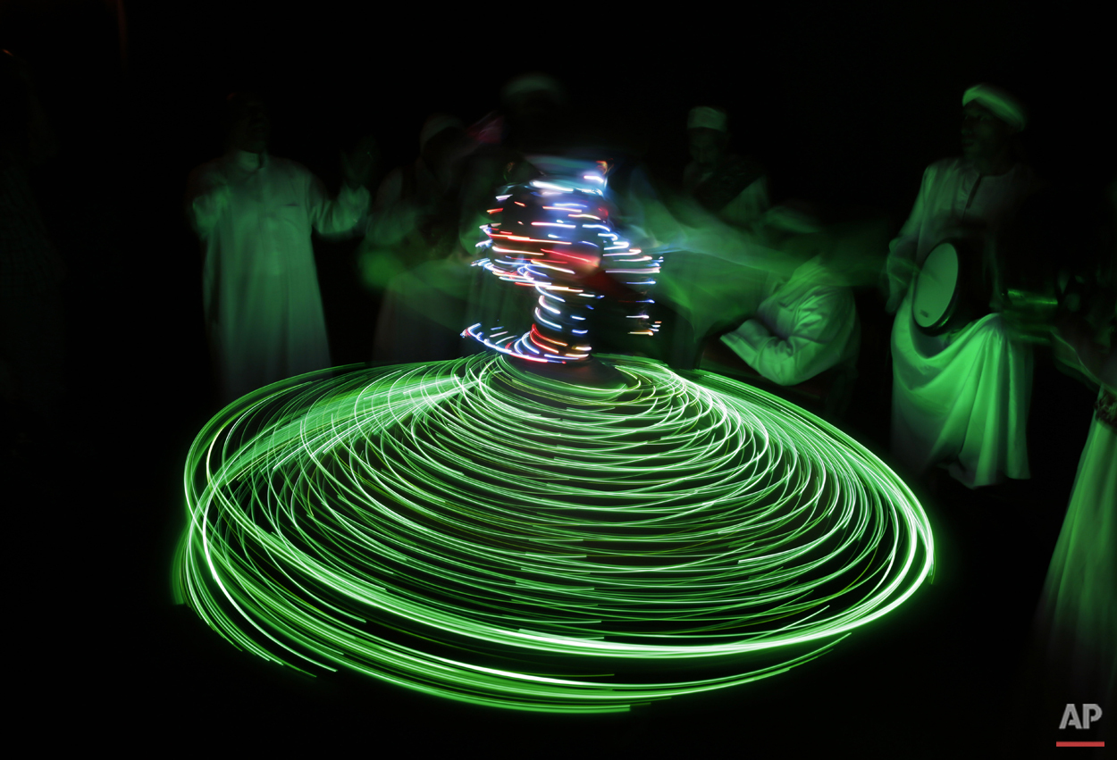 In this Thursday, April 30, 2015 photo, a whirling dervish with the Al-Tannoura Egyptian Heritage Dance Troupe spins the El Dammah Theatre in Cairo, Egypt. (AP Photo/Amr Nabil)