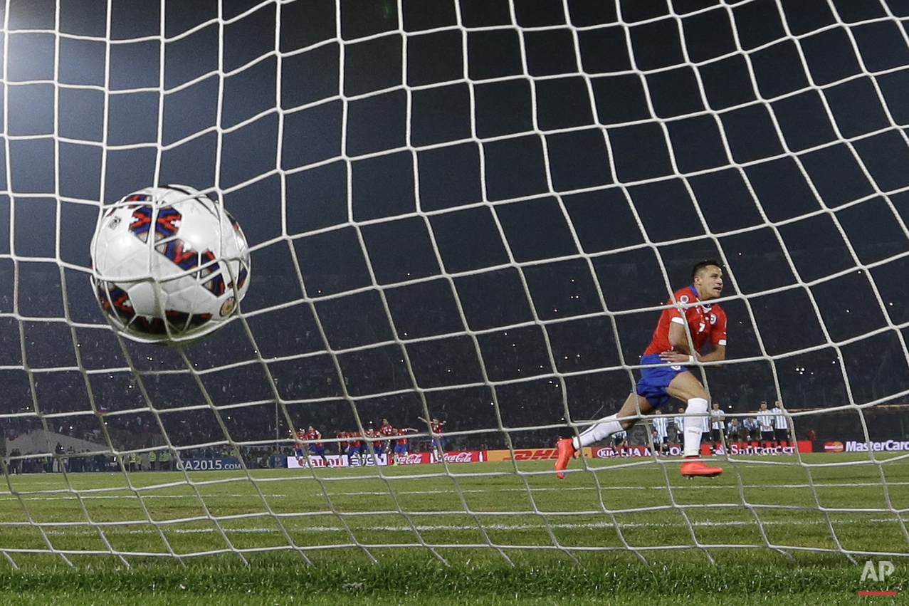 Chile's Alexis Sanchez celebrates after scoring the winning penalty kick against Argentina during the Copa America final soccer match at the National Stadium in Santiago, Chile, Saturday, July 4, 2015. Chile became Copa America champions for the first time after it defeated Argentina in a penalty shootout. (AP Photo/Ricardo Mazalan)