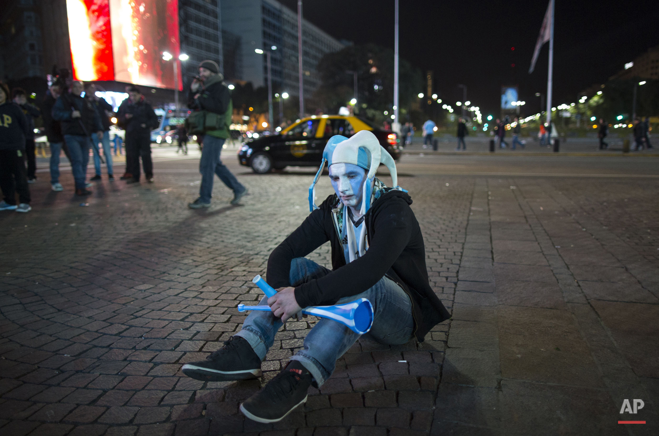 An Argentina soccer fan sits on the sidewalk after watching his team loose the final Copa America match to Chile, in downtown Buenos Aires, Argentina, Saturday, July 4, 2015. Argentina lost in a penalty shootout. (AP Photo/Ivan Fernandez)