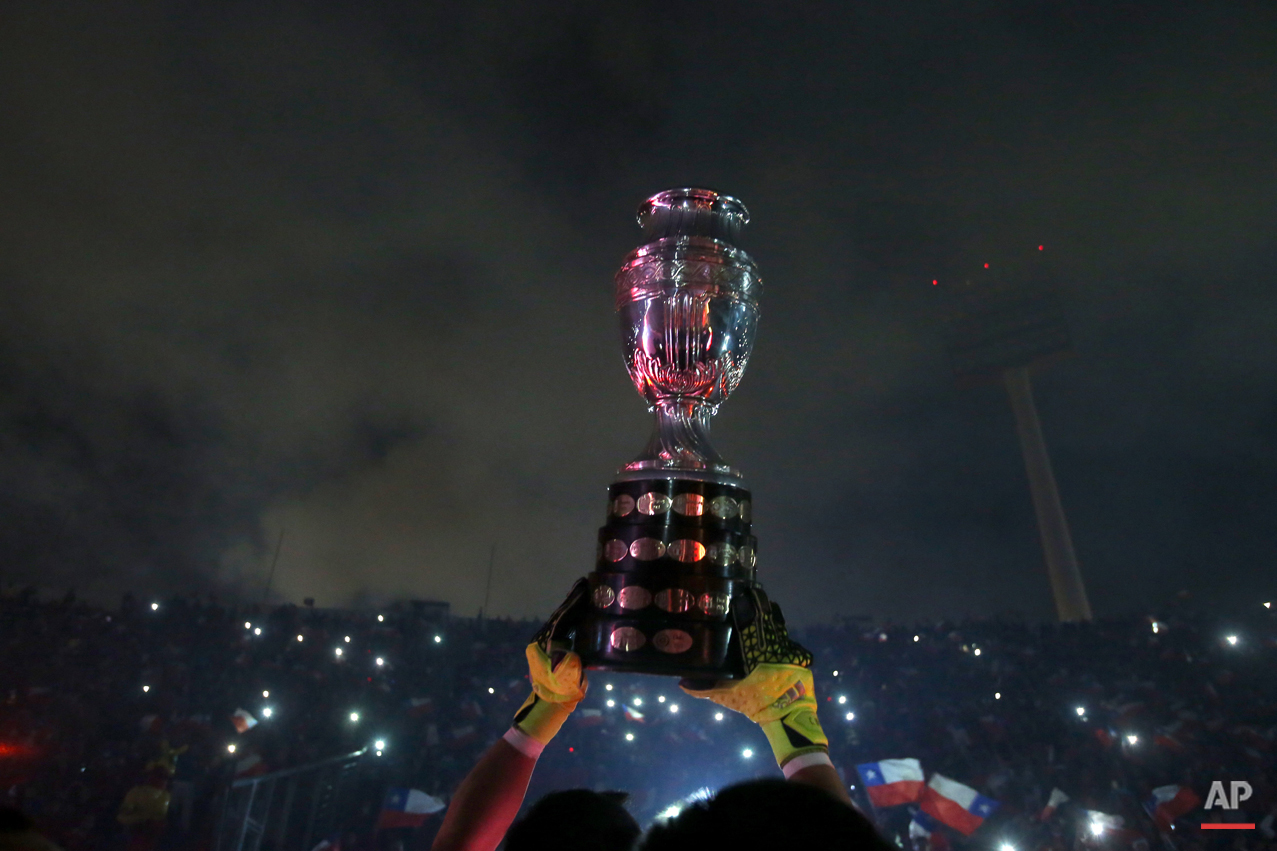 Chile's goalkeeper Claudio Bravo lifts the Copa America trophy after defeating Argentina in the final soccer match at the National Stadium in Santiago, Chile, Saturday, July 4, 2015. Chile became Copa America champions for the first time after defeating Argentina in a penalty shootout. (AP Photo/Luis Hidalgo)