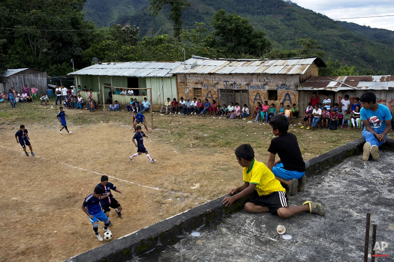 In this March 15, 2015 photo, young men compete in a multi-village soccer tournament, in La Mar, province of Ayacucho, Peru. A hardy lot, cocaine backpackers are mostly native Quechua speakers and hail from the isolated communities that suffered the worst atrocities of Peru’s 1980-2000 dirty war with Shining Path rebels. (AP Photo/Rodrigo Abd)
