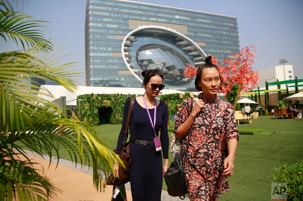 In this Feb. 2, 2017 photo, Anjali Lama, left, a transgender model from Nepal, arrives to take part in Lakme Fashion week in Mumbai, India. Growing up as the fifth son in a poor farming family in rural Nepal the dream to be a fashion model came late in life. First came a long, painful struggle to accept that he felt deeply female. It was a chance encounter with a group of transgender women that turned Lama's life around by putting her in touch with the Blue Diamond Society, an advocacy group for Nepal's LGBT community. In 2005, she came out to her friends and family as a transgender woman. (AP Photo/Rafiq Maqbool)