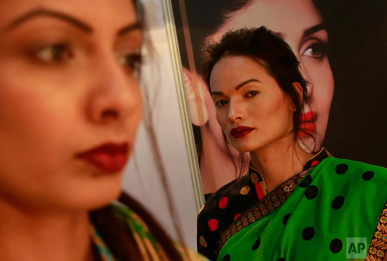 In this Feb. 2, 2017 photo, Anjali Lama, a transgender model from Nepal, stands backstage at the Lakme Fashion week in Mumbai, India. Growing up as the fifth son in a poor farming family in rural Nepal the dream to be a fashion model came late in life. First came a long, painful struggle to accept that he felt deeply female. It was a chance encounter with a group of transgender women that turned Lama's life around by putting her in touch with the Blue Diamond Society, an advocacy group for Nepal's LGBT community. In 2005, she came out to her friends and family as a transgender woman. (AP Photo/Rafiq Maqbool)