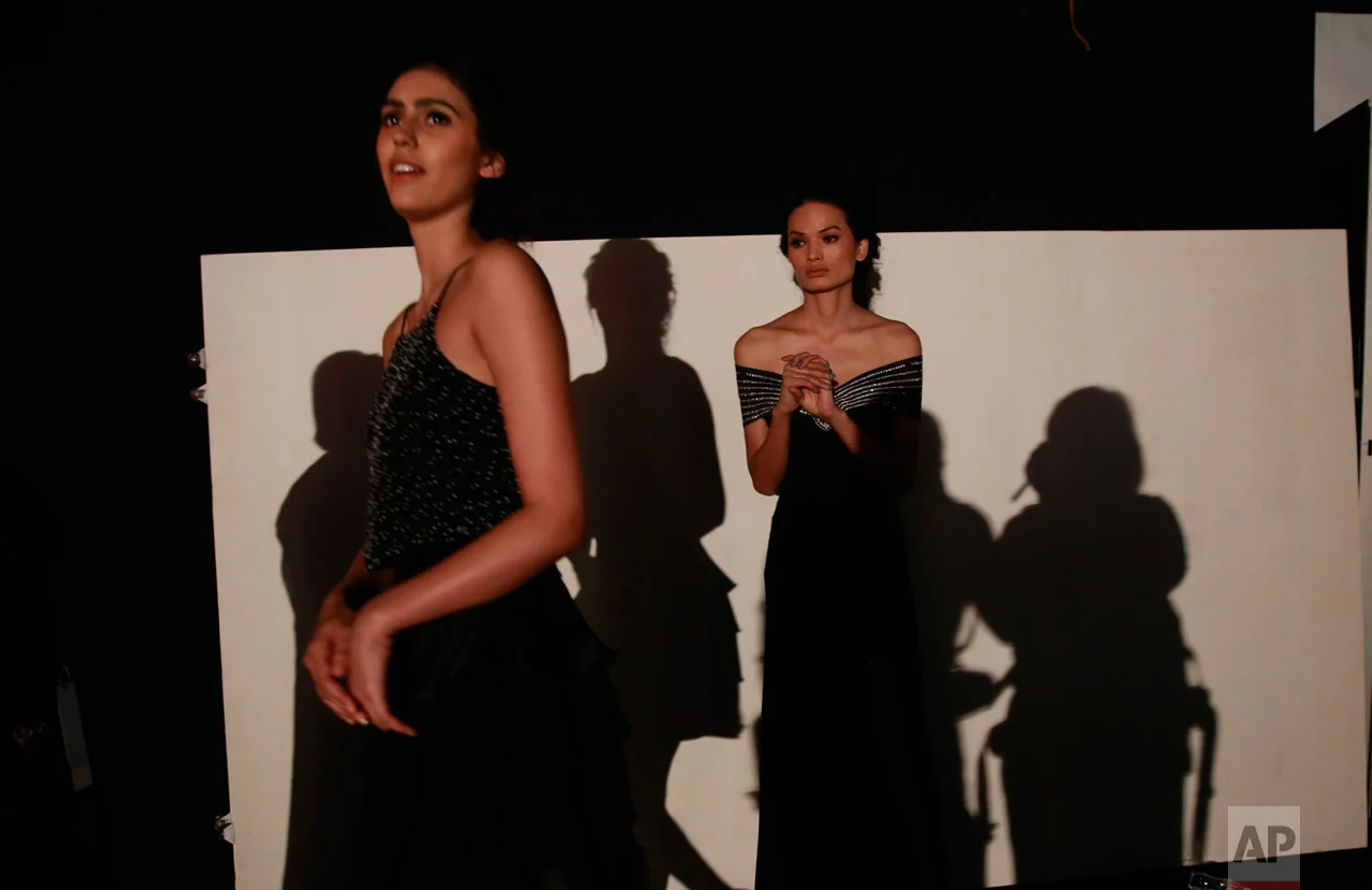 In this Feb. 1, 2017 photo, Anjali Lama, right, a transgender model from Nepal, waits backstage for her turn to walk the ramp during Lakme Fashion week in Mumbai, India. To model for Lakme Fashion Week, one of the highlights of India's fashion calendar, is Lama's big moment. It's a dream that was years in the making and often seemed far beyond the reach of Lama now being touted as the first transgender woman to model for the high fashion event sponsored by a top Indian cosmetics brand. (AP Photo/Rafiq Maqbool)