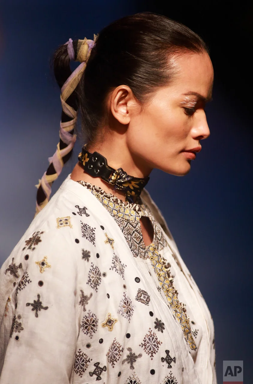 In this Feb. 2, 2017 photo, Anjali Lama, a transgender model from Nepal, walks the ramp at the Lakme Fashion week in Mumbai, India. Growing up as the fifth son in a poor farming family in rural Nepal the dream to be a fashion model came late in life. First came a long, painful struggle to accept that he felt deeply female. It was a chance encounter with a group of transgender women that turned Lama's life around by putting her in touch with the Blue Diamond Society, an advocacy group for Nepal's LGBT community. In 2005, she came out to her friends and family as a transgender woman. (AP Photo/Rafiq Maqbool)