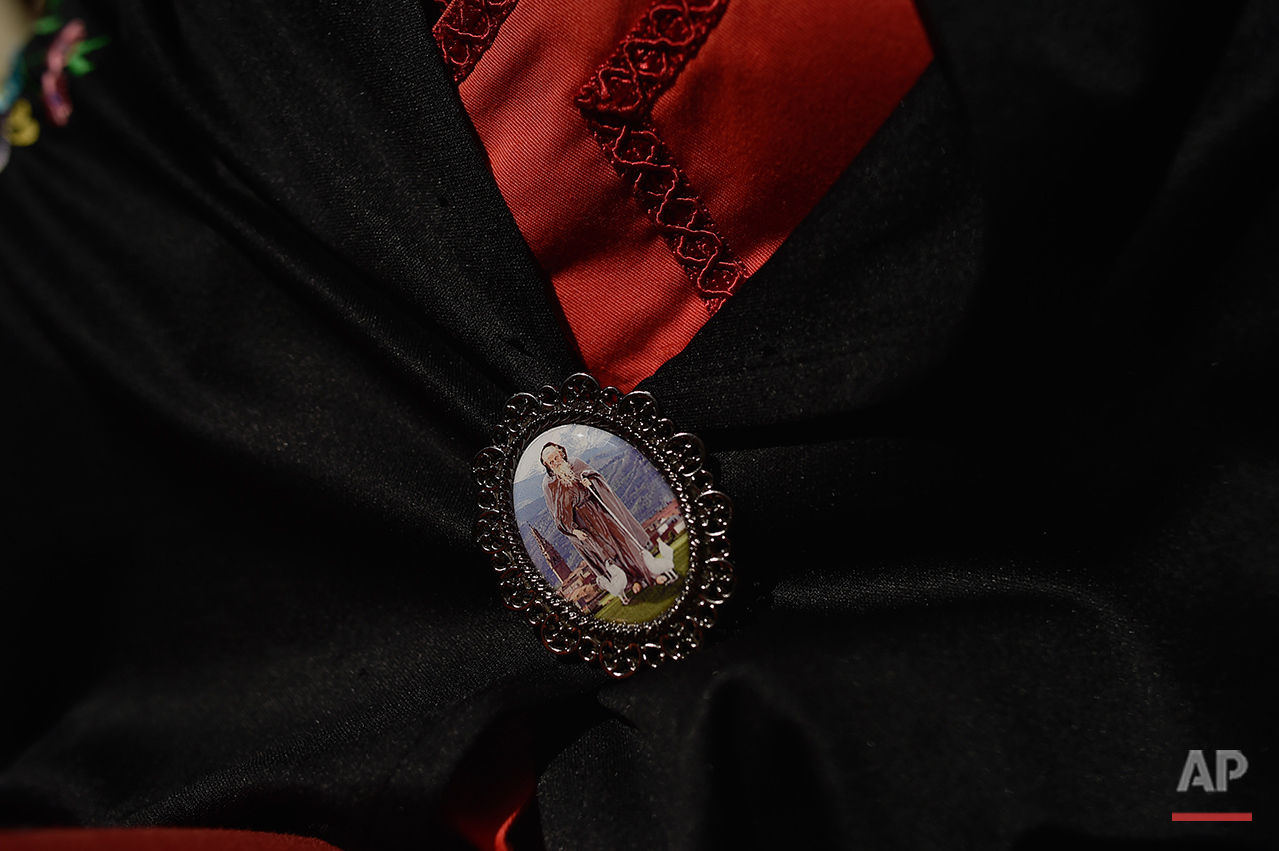  A participant in the ''Bread Procession of the Saint'', holds a medallion with a figure of Domingo de La Calzada Saint in the ceremony in honor of this Saint (1019-1109), in Santo Domingo de La Calzada, northern Spain, Wednesday, May 11, 2016.  Ever