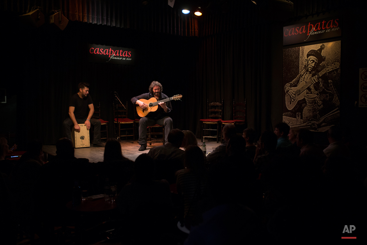  In this Wednesday, Nov. 11, 2015 photo, Spanish 'flamenco' guitarist Camaron de Pitita, right, performs with another artist during a show at the Casa Patas flamenco club in Madrid. Spanish flamenco guitars are known for their beautiful shape, rich w