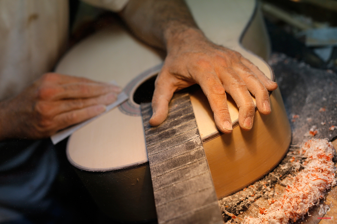  In this Wednesday, Nov. 11, 2015 photo, Spanish guitar maker Mariano Conde works at his workshop in Madrid. Carrying on the family tradition is Mariano Conde, who operates out of his workshop in downtown Madrid where and he and his son, also called 