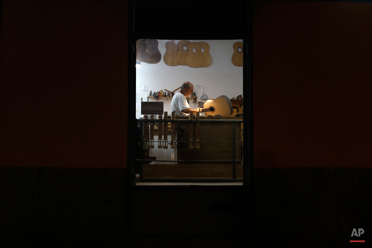  In this Wednesday, Nov. 11, 2015 photo, Spanish guitar maker Mariano Conde works at his workshop in Madrid. Carrying on the family tradition is Mariano Conde, who operates out of his workshop in downtown Madrid where and he and his son, also called 