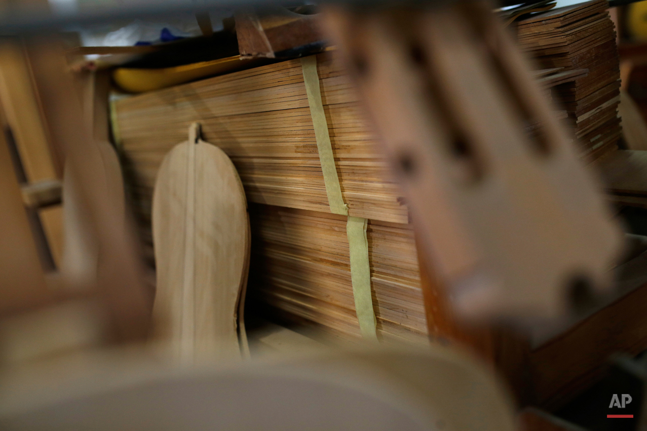  In this Tuesday, Nov. 17, 2015 photo pieces of wood to make 'flamenco' guitars are piled in a workshop in Madrid. Spanish flamenco guitars are known for their beautiful shape, rich wood colors and full-bodied, crisp musical tones. (AP Photo/Francisc