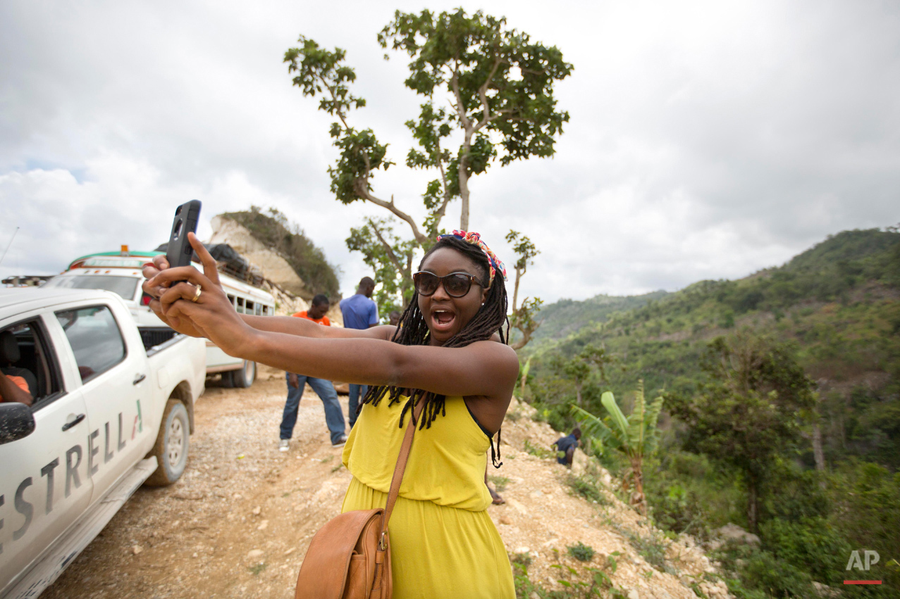  In this July 15, 2015 photo, adoptee Mariette Williams takes a selfie in Deron, a neighborhood on the outskirts of Pestel, Haiti. Mariette, who was adopted by a Canadian couple in October 1986, was recently reunited with her birth mother, Cola Etien